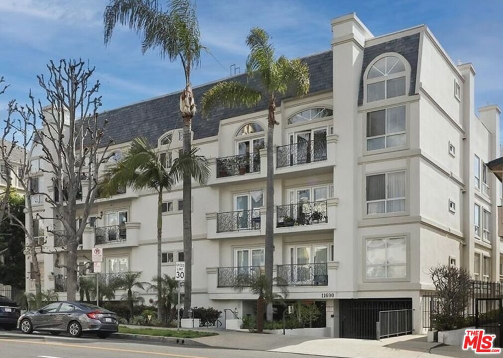 Completely remodeled penthouse in "Villa Monet". Prime Brentwood location close to coffee bars, restaurants & retail on trendy San Vicente Blvd. Elegant double door entry with 18' ceilings & skylight. Spacious living room, also with 18' high ceilings, fireplace & large windows with plantation shutters, allowing in tons of natural light. Exquisite open kitchen with quartz counters, custom cabinets & stainless steel appliances including Viking range/oven. Super hip bar/sitting area finished with quartz counter & wine cooler. Primary bedroom with huge windows, also with plantation shutters, fireplace, and large walk-in closet. Beautifully remodeled primary bathroom with dual sinks, large walk in shower and free standing tub. Second bedroom/loft with en-suite bathroom & access to huge outdoor patio area with separate sitting and dining areas. Gorgeous wood floors. Full laundry room. Additional storage inside the unit and in the garage. Villa Monet has an indoor swimming pool and secure guest parking