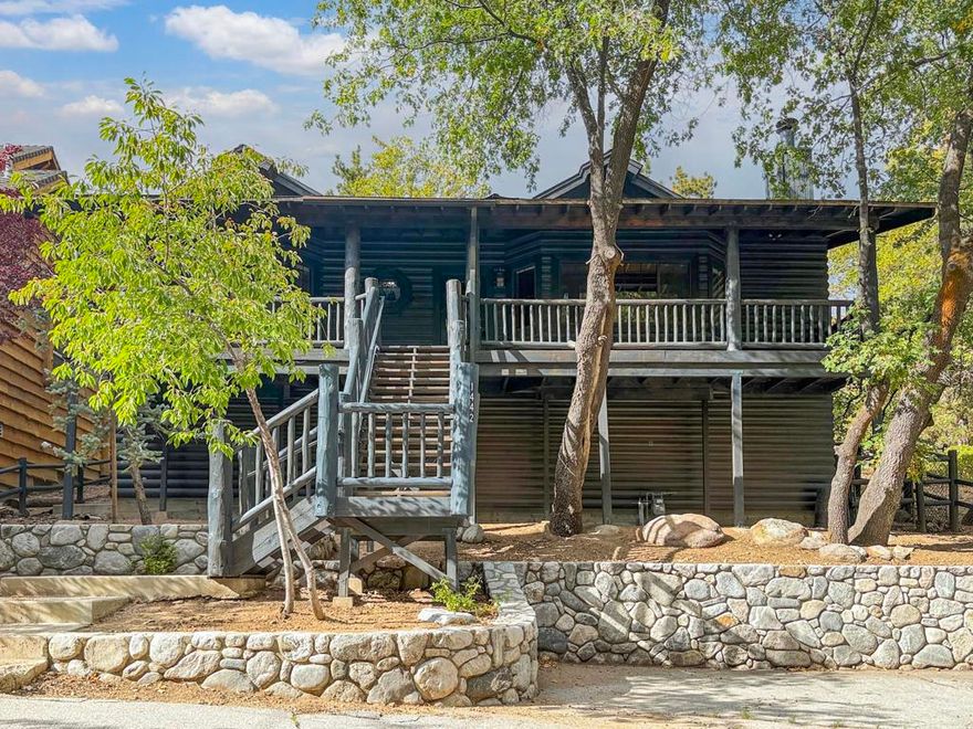 A true mountain escape in a premier Moonridge location--just a block from Bear Mountain Ski Resort and steps from the National Forest. This log-sided retreat offers an authentic mountain feel in a peaceful treehouse-like setting. Nestled on a heavily treed lot, it's the ideal spot for both adventure and relaxation. The inviting great room features a rock/brick fireplace, wood-beamed ceilings with recessed lighting, and log-accented walls--warm, open, and designed for cozy gatherings. Large windows frame the surrounding oaks and pines and bring the outdoors in. The eat-in kitchen offers glass-faced cabinets, tile counters, and plenty of space to prepare meals while enjoying the view. Each bedroom has wood accents and wainscoting, creating comfortable spaces for family and guests. A covered front porch sets the tone for a true cabin escape, while the spacious back deck is perfect for barbecues, entertaining, or simply soaking in the serenity of the forest. Located just one block from Bear Mountain and steps to hiking and biking trails, this home provides quick access to year-round recreation. The lake, golf course, and Village shops and restaurants are only a short drive away, making it convenient for both locals and visitors alike. With its sought-after Moonridge location, log-style design, and remarkable setting, this property would make an excellent weekend getaway, and/or high-demand vacation rental. A rare opportunity to own a true Big Bear cabin in one of the most desirable areas on the mountain.
