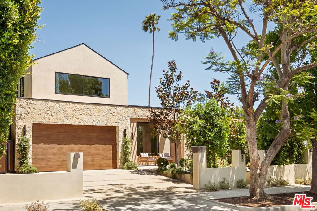 Presenting a stunning 2025 architectural masterpiece in the heart of prime Beverly Grove/West Hollywood re-imagined by Casa Design. This stone-clad modern farmhouse seamlessly blends timeless elegance with contemporary design, showcasing clean lines, organic materials, and expansive, light-filled interiors. The open-concept chef's kitchen features top-tier finishes and flows effortlessly into the great room, where disappearing glass walls create a seamless indoor-outdoor experience. The backyard is a private resort-style escape with a pool, turfed lawn, and built-in BBQperfect for year-round entertaining. Four en suite bedrooms include a luxurious primary suite wrapped in marble, complete with a spa-style bath and bespoke finishes. Every detail reflects exceptional craftsmanship and a dedication to elevated living.