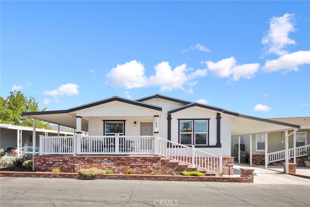 This stunning 2019 Fleetwood manufactured home combines modern comfort with timeless style. Featuring 3 bedrooms, 2 bathrooms, and 1,610 sq. ft. of single-level living space, it’s thoughtfully designed for convenience, function, and beauty. The vaulted, open-concept living area creates a bright and welcoming atmosphere, perfect for both relaxation and entertaining. The chef-inspired kitchen showcases stainless steel appliances, a large center island, abundant counter space, and seamless integration with the dining and living rooms. The spacious primary suite offers a walk-in closet and private bath, while a large laundry room with sink adds both functionality and storage. Additional highlights include central A/C and heating for year-round comfort, elegant crown molding, stylish window coverings, an expansive wraparound porch with vinyl railing, and a full-length covered carport. The side yard features a concrete patio, an ideal spot to relax and enjoy the beautifully landscaped surroundings. Life at The Fountains, a desirable 55+ community, means more than just a beautiful home. Residents enjoy exceptional amenities, including a clubhouse, sparkling pool and spa, fitness center, library, and game room, providing endless opportunities to stay active, social, and engaged. This move-in ready home offers the perfect blend of comfort, community, and lifestyle in the heart of La Verne.