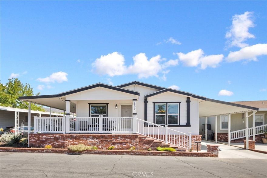 This stunning 2019 Fleetwood manufactured home combines modern comfort with timeless style. Featuring 3 bedrooms, 2 bathrooms, and 1,610 sq. ft. of single-level living space, it’s thoughtfully designed for convenience, function, and beauty. The vaulted, open-concept living area creates a bright and welcoming atmosphere, perfect for both relaxation and entertaining. The chef-inspired kitchen showcases stainless steel appliances, a large center island, abundant counter space, and seamless integration with the dining and living rooms. The spacious primary suite offers a walk-in closet and private bath, while a large laundry room with sink adds both functionality and storage. Additional highlights include central A/C and heating for year-round comfort, elegant crown molding, stylish window coverings, an expansive wraparound porch with vinyl railing, and a full-length covered carport. The side yard features a concrete patio, an ideal spot to relax and enjoy the beautifully landscaped surroundings. Life at The Fountains, a desirable 55+ community, means more than just a beautiful home. Residents enjoy exceptional amenities, including a clubhouse, sparkling pool and spa, fitness center, library, and game room, providing endless opportunities to stay active, social, and engaged. This move-in ready home offers the perfect blend of comfort, community, and lifestyle in the heart of La Verne.