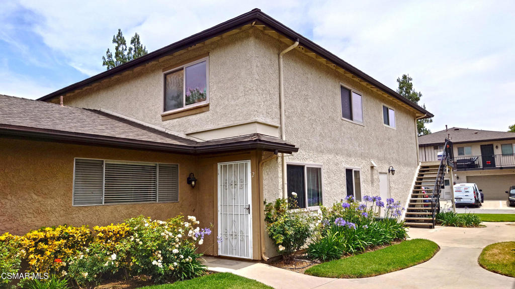 Discover your new home in East Simi Valley! This clean, move-in-ready condo offers comfort and convenience. Enter through a low-maintenance wood type fiberglass front door with a security screen into a freshly painted interior. The lower level features durable tile flooring and a ceiling fan in the dining area. The kitchen includes white cabinets, white tile countertops, a stainless steel sink, matching white appliances, recessed lighting, and a large pantry. Upstairs, you'll find two spacious bedrooms, one with a walk-in closet and a makeup vanity with mirror and lighting, and the other with mirrored closet doors. The full bathroom has a tiled shower/tub combo, a mirrored medicine cabinet, white cabinets, and a stainless faucet. Linen cabinets in the hallway add extra storage. dual-pane Milgard windows throughout keep the home comfortable and quiet, and parking is easy with a one-car garage and an additional designated space. Located just steps from the community pool, spa and playground, with plenty of guest parking nearby, this condo is perfectly situated in a vibrant neighborhood. Enjoy the best of East Simi Valley, with shops, restaurants, top-rated schools, and more right at your doorstep.