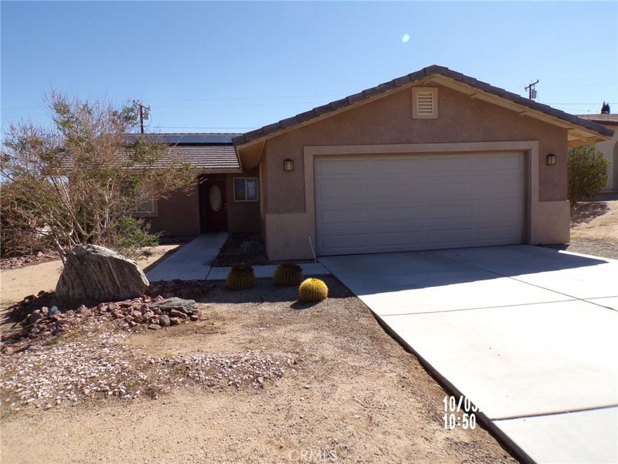 Spacious 4-bedroom, 2-bath home located in the peaceful Indian Cove neighborhood of 29 Palms. Perfectly situated just a short drive from Joshua Tree National Park and the Marine Corps Base, this home offers both convenience and comfort. Step inside to find an open-concept kitchen seamlessly connected to the living area—ideal for entertaining or relaxing by the cozy fireplace. The primary suite features a walk-in closet and a private bath with double sinks, providing a perfect retreat at the end of the day.  Split floor plan gives space between primary and the other 3 bedrooms. Enjoy the outdoors year-round on the covered patio, or make use of the attached garage for parking and extra storage. This home combines practical living with desert charm and is ready for you to make it your own.