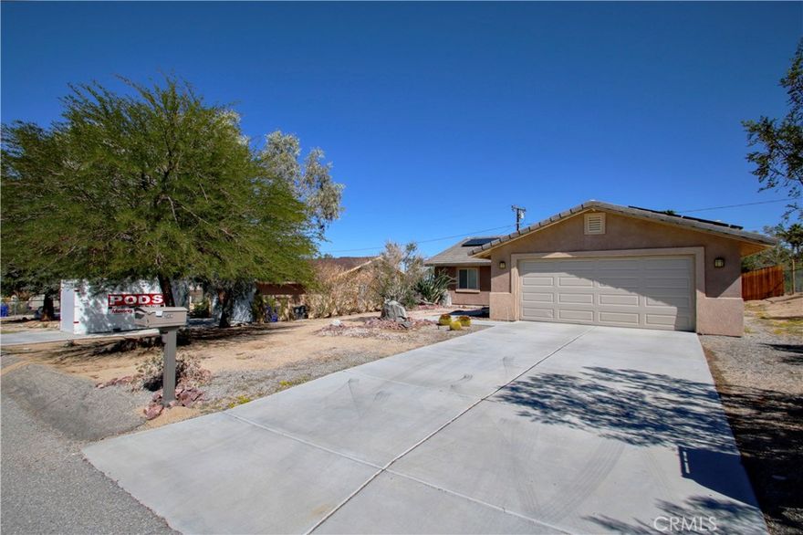 Spacious 4-bedroom, 2-bath home located in the peaceful Indian Cove neighborhood of 29 Palms. Perfectly situated just a short drive from Joshua Tree National Park and the Marine Corps Base, this home offers both convenience and comfort. Step inside to find an open-concept kitchen seamlessly connected to the living area—ideal for entertaining or relaxing by the cozy fireplace. The primary suite features a walk-in closet and a private bath with double sinks, providing a perfect retreat at the end of the day.  Split floor plan gives space between primary and the other 3 bedrooms. Enjoy the outdoors year-round on the covered patio, or make use of the attached garage for parking and extra storage. This home combines practical living with desert charm and is ready for you to make it your own.