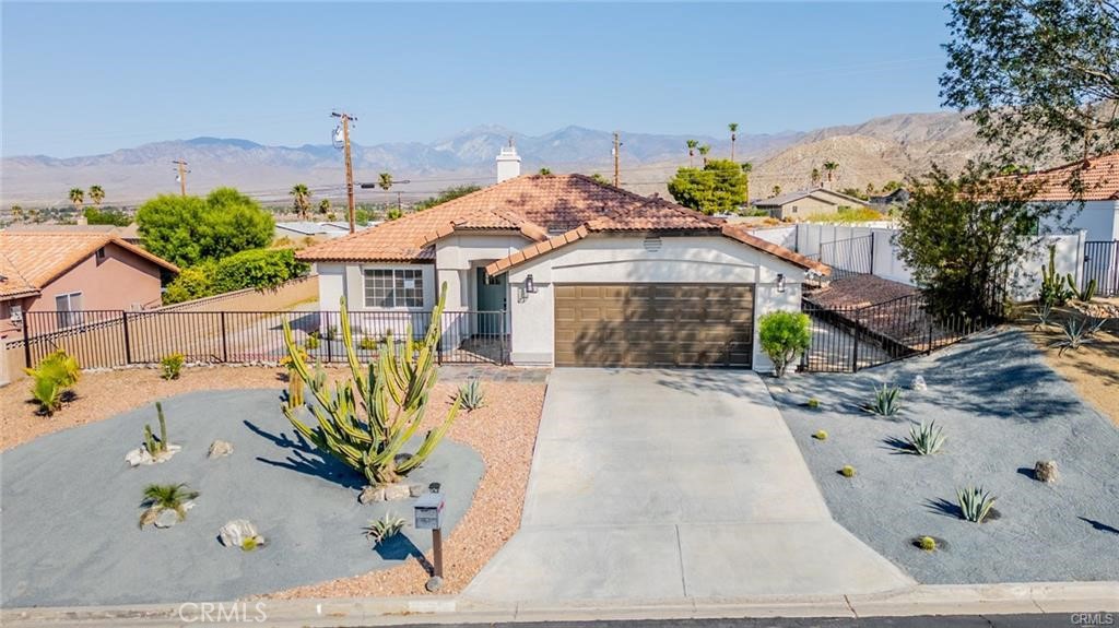 Welcome to your perfect One story home in the city of Desert Hot Springs with an amazing floor plan and upgrades! Perfect blend of style and comfort, this home is ready to create lasting memories. three spacious bedrooms and two bathrooms, all situated on a generous 7,405 sq. ft. lot. The family room has a cozy fireplace with NEW Tile surround with natural lighting creating a warm and inviting atmosphere. The home boasts thoughtful updates including: New carpet in the bedrooms. Freshly painted interior and exterior. A beautifully updated Kitchen with New quartz countertops, a stylish tile backsplash, and all-new stainless steel appliances, sink and fixtures.. Enjoy the spacious front and backyard—perfect for relaxing, entertaining, or hosting family barbecues. The home also features an attached two-car garage for added convenience. The home also features an attached two-car garage for added convenience.. Located just minutes from shopping centers and major freeways, this home truly has it all. Don’t wait—schedule your showing today!