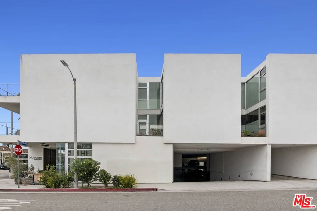 Rarely available LIVE/WORK in the best part of Abbot Kinney! Experience a truly walkable lifestyle in this architectural mixed-use building. Located just blocks from the beach on Abbot Kinney Blvd with its vibrant shopping and dining scene, this tasteful, minimalist apartment gets tons of natural light from large windows offering iconic L.A. views of palm trees. Situated one floor above a vibrant streetscape and accessed via a private garden courtyard, the lower level consists of an open living/dining and kitchen area, powder room and terrace. Upstairs is a bedroom, the primary bath and a study that can also function as a second bedroom. High-end features include polished concrete and Ipe wood floors, teak Euro-style cabinetry, pocket doors, Subzero and Bosch appliances, Miele washer-dryer and a garden with native plants. Unit come with two secured parking spots. s x s