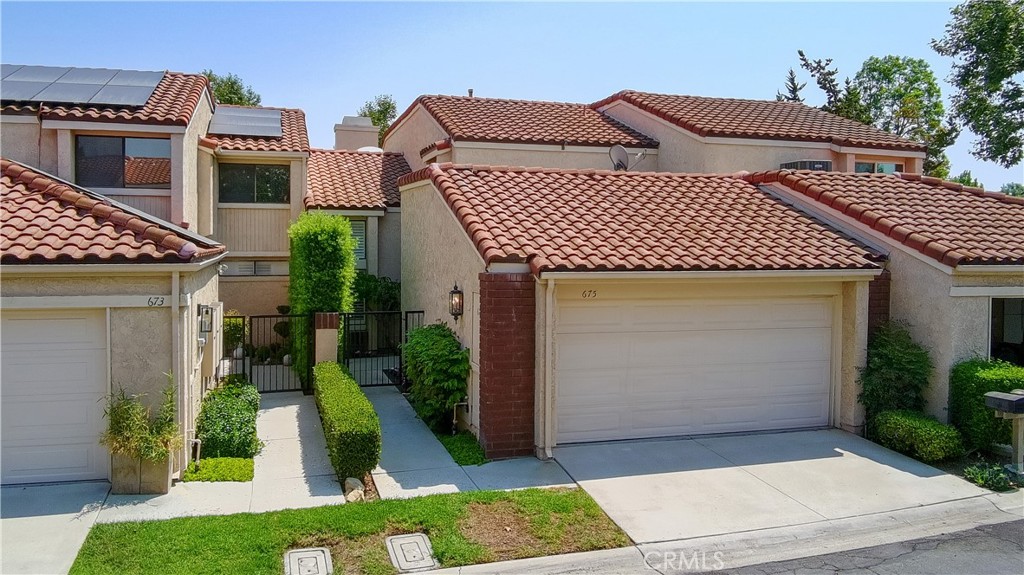 Introducing 675 Colonial Circle in Fullerton, a beautifully maintained and thoughtfully upgraded home located in a secure, gated community offering the perfect blend of comfort and style. This spacious 3-bedroom, 3-bathroom residence features 1,963 square feet of well-designed living space, highlighted by high ceilings and a bright, open floor plan. As you step inside, you’ll immediately notice the fresh upgrades throughout. Brand new floor tiles and modern laminate flooring enhance the home’s contemporary aesthetic while natural light flows freely through every room, creating a warm and inviting atmosphere. The newly remodeled kitchen is a true standout, featuring elegant white cabinetry, gleaming quartz countertops, a sleek backsplash, and stainless steel appliances, ideal for both everyday living and entertaining guests. Just off the kitchen, the dining and family room flow seamlessly together, providing a spacious and functional layout. Upstairs, the primary suite offers a peaceful view from its balcony, complete with a beautifully upgraded shower with custom-tiled walls and glass doors, and well maintained tub for a spa-like experience. Two additional bedrooms and bathrooms provide plenty of space for family, guests, or a home office setup. Step outside to your private back patio, which opens to a serene greenbelt perfect for morning coffee, evening relaxation, or hosting friends and family. A spacious two-car garage offers added convenience and storage. The community itself features a range of amenities designed to elevate your lifestyle, including sparkling swimming pools, and courts for basketball, tennis, and pickleball all within walking distance. Ideally located just minutes from top-rated schools such as Beachwood Elementary and Troy High School, as well as Cal State Fullerton, Downtown Brea, and Brea Mall, this home provides easy access to dining, shopping, and entertainment options. This move-in ready home truly combines modern upgrades, comfortable living, and an unbeatable location- a rare opportunity in one of Fullerton’s most desirable communities.