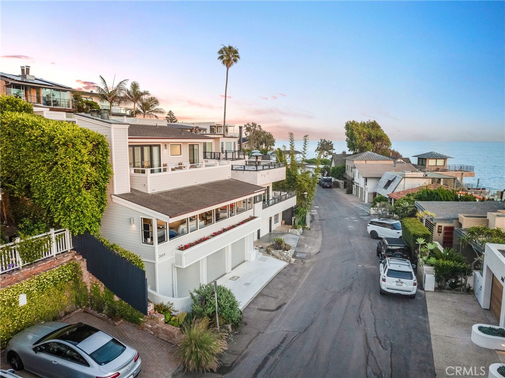 Experience the best of Laguna Beach living in this timeless coastal home at 2664 Victoria, where panoramic views of the Pacific Ocean and Catalina Island stretch from nearly every room. Set just steps from the sand at iconic Victoria Beach, this residence offers a rare blend of breathtaking scenery, upscale amenities, and an effortlessly walkable location. Inside, spacious living and dining areas showcase spectacular coastal vistas, complemented by Warren Christopher European oak custom hardwood floors throughout. The updated kitchen features premium appliances, including a Viking range, Bosch dishwasher, and LG refrigerator. The primary suite is a serene retreat with a cozy fireplace, walk-in closet, ensuite bath, and private balcony overlooking sunset views. A second ensuite bedroom includes custom window treatments, while multiple patios and decks provide seamless indoor-outdoor living. At the top, an open-air balcony captures truly awe-inspiring views. The beautifully landscaped backyard is designed for relaxed entertaining, complete with new irrigation and lighting systems. A rare three-car garage offers ample parking and storage—an uncommon luxury in this beachside enclave. Victoria Drive is beloved by locals for its peaceful, tucked-away feel, just minutes from Laguna’s renowned restaurants, galleries, and shops. Whether as a full-time residence or a coastal escape, this home embodies comfort, beauty, and barefoot luxury.
