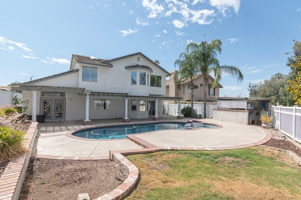 4 bedroom, 3 bathroom, upgraded swimming pool home in Murrieta with a paid for solar system! The downstairs bedroom includes a large closet with mirrored doors, a ceiling fan, and a nearby 3/4 bathroom with granite countertops. The family room includes a dry bar, a fireplace, and a sliding glass door connecting to the backyard. The kitchen includes an island, granite countertops, backsplash, a gas stove top, double-ovens, and stainless steel appliances (refrigerator included). The formal dining area includes French doors connecting to the backyard. The living room has a vaulted ceiling. There is crown molding downstairs. Upstairs you will find a loft with a vaulted ceiling and a ceiling fan, 2 additional secondary bedrooms, and the master bedroom. Both upstairs secondary bedrooms are off the loft and have a nearby full bathroom with granite countertops, dual sinks and a tile surround tub/shower. One of the upstairs secondary bedrooms has mirrored closet doors and the other has a ceiling fan. The master bedroom includes a vaulted ceiling and a ceiling fan. The master bathroom includes a separate tub & shower, a skylight, a vaulted ceiling, dual sinks, quartz countertops, and two closets - one is a walk-in and the other has mirrored doors. The backyard includes the swimming pool with attached spa, a covered patio and motion lights. Open space directly behind the property. Nicely landscaped back and front yards. Other features include front entry Travertine tile, drought tolerant front landscaping, a 3-car garage, a whole-house water softener, a park across the street, and nearby shopping & eateries. Relatively low property taxes. No HOA.