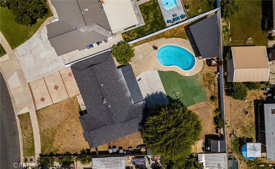 Welcome to this inviting 3-bedroom, 2-bathroom home nestled on a massive 12,000+ sq ft pie-shaped lot in one of Riverside’s most attractive neighborhoods. With wide, well-kept streets and pride of ownership throughout the community, this property offers a rare combination of space, potential, and charm. Step inside to discover a smart and semi-open layout anchored by a striking central fireplace, creating a warm focal point between the living and dining areas. The kitchen was tastefully remodeled just three years ago and flows seamlessly into the common areas, making entertaining a breeze. The primary bedroom includes French doors that open to your dream backyard, creating a true indoor-outdoor experience.

Outside, the possibilities are endless. The sprawling backyard features a sparkling pool, an open patio perfect for BBQs, and a large storage shed. The oversized driveway fits up to four vehicles, and a side access gate allows for additional parking or storage—ideal for work trucks, toys, or equipment.

And here’s the kicker: this home comes with a city-approved and permitted ADU (Accessory Dwelling Unit) conversion in progress! The garage is in the framing and electrical rough-in stage and will become a 1-bedroom, 450 sq ft unit with a separate entrance—perfect for extended family, rental income, or a private home office. Plans and sketches are available to transfer to the next owner, offering built-in equity and future potential.

This is a truly special opportunity—a great home on an incredible lot with room to grow.