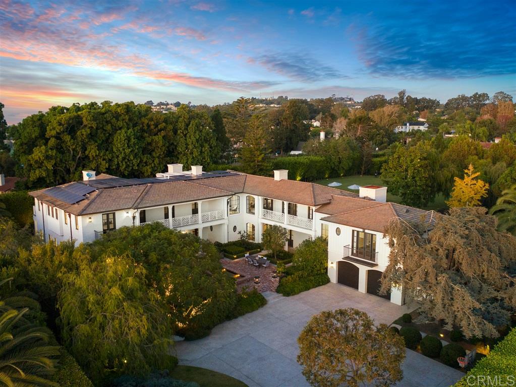 Built in 2013 to the highest standards, this exceptional home embodies timeless quality, design, and an A+ location, making it one of La Jolla's finest estates. Offering immeasurable pleasure, comfort, and inspiration, this private residence captures the essence of luxury living. Thoughtfully constructed on 2 of 3 parcels totaling nearly 1.4 acres, the fully gated property is surrounded by beautiful landscaping and mature hedges, ensuring privacy. With a California Traditional style that is barely visible from the street, this exquisite home features two above-grade levels. The main level includes a spacious living room, dining room, and family room designed by renowned designer Jeffrey Bilhuber for seamless flow and entertaining. There are also home offices located off the kitchen and primary suite. Pocketing screen doors create a seamless connection between indoor and outdoor spaces, including a covered patio off the family room that epitomizes La Jolla's beloved indoor/outdoor living experience. The upper level boasts an impressive primary bedroom suite with sitting areas, a fireplace, large shower, his and hers closets and toilets, and a private balcony with a therapeutic spa and fireplace. There are also 4 additional bedroom suites on this upper level, and a secondary primary suite on the entry level. Additional features of this remarkable home include a wine cellar, theater room with bar, extensive storage, and an 18+ car showroom that offers incredible flexibility for various uses such as a gym, golf simulator, recording studio, and/or bowling alley. The meticulously designed grounds include a large UV pool with underwater speakers, ample lawn and garden areas designed by Art Luna. There is also potential to build a pool house, sport court, or re-partition and sell or develop the land. A new home built on the annexed lot would also have ocean views from the second story. In-wall speakers, laundry facilities on both levels, bathrooms with Toto washlets, polished nickel Waterworks Plumbing fixtures with Speakman showerheads, heated floors, elevator access to all levels, and extensive smart home technology are just a few examples of the attention to detail and luxurious amenities that make this home so special.