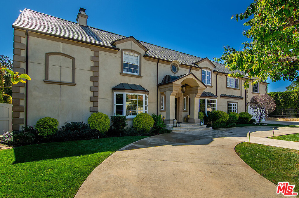 Situated near the Riviera Country Club, this five-bedroom home with utmost privacy embraces the beauty of coastal living. The spectacular gated estate is on one of the most desirable streets in the Upper Riviera. Filled with an abundance of natural light and soothing colors, this home boasts impeccable craftsmanship and inspired amenities, hardwood and stone floors, high ceilings, stainless steel appliances, pool, spa, built-in barbecue, and more. The main level features two fireplaces, a formal dining room, a living room, an enormous family room with a bar area, an office/guest room, and a gourmet kitchen with a breakfast area. Perfect for entertaining with two separate staircases that allow you to retreat upstairs to the master suite with a soaking tub and glass-enclosed shower, two spacious closets, fireplace, and balcony with treetop views. Three additional bedrooms complete the second floor.