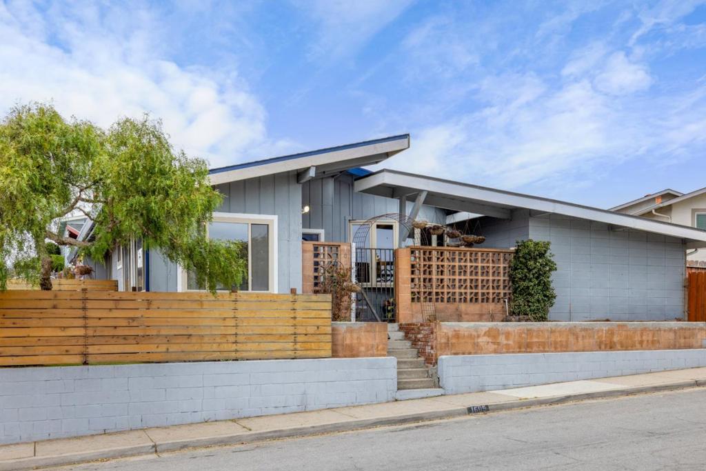 Welcome to this charming 2,299 sq. ft. home (buyer to verify square footage) located in the picturesque city of Seaside. Nestled on a lot size of approximately 3,800 sq. ft. (buyer to verify), this residence offers four bedrooms, one updated full bathroom featuring a shower over tub, skylight, and a half bath with walk-in tub in the primary bedroom. The original structure has been expanded on at least two occasions, once to convert a large outdoor patio into a living room and a second time to add a fourth bedroom and laundry. The recently renovated kitchen is equipped with an electric oven range, refrigerator, and pantry, making meal preparation a delight. Open beam, vaulted ceilings enhance the home's spacious feel, complemented by a bay window that adds unique architectural interest. Laminate, vinyl, and wood flooring flow throughout the house, combining functionality and aesthetic appeal. Enjoy cozy evenings by the fireplace in the separate family room, where a dining area is conveniently located. The large living room area has a separate fireplace, perfect for ambiance while entertaining family and friends. Although there is no garage, additional storage needs are met by outdoor storage sheds. Don't lose this opportunity to own a beautiful home in the mid-Broadway area.