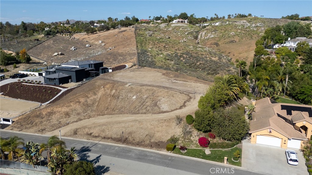 Welcome to 7390 Corinthian Way! Hidden in the coveted estates off of Overlook dr. this beautiful 1.03 acer panoramic parcel combines the perfect level of seclusion and accessibility. With an elegant graded driveway , grandiose flat pad, spectacular views and even fully approved 2 story plans for a magnificent 6540 sqft home pictured above this affordably priced parcel is ready for your dream home to become a reality without all of the backbreaking work with the city. The approved plans come with a full soil report, survey, grading plans and probably most valuable asset, a variance to build this two-story mansion exceeding the strict regulation of a 1 story development in the area. With homes selling in the 2.0-4.5-million-dollar range in this area this this home will be perfect for your forever home or a fantastic development for sale. If there are any questions further that you may have, please feel free to call me and I hope you enjoy this wonderful piece of land.