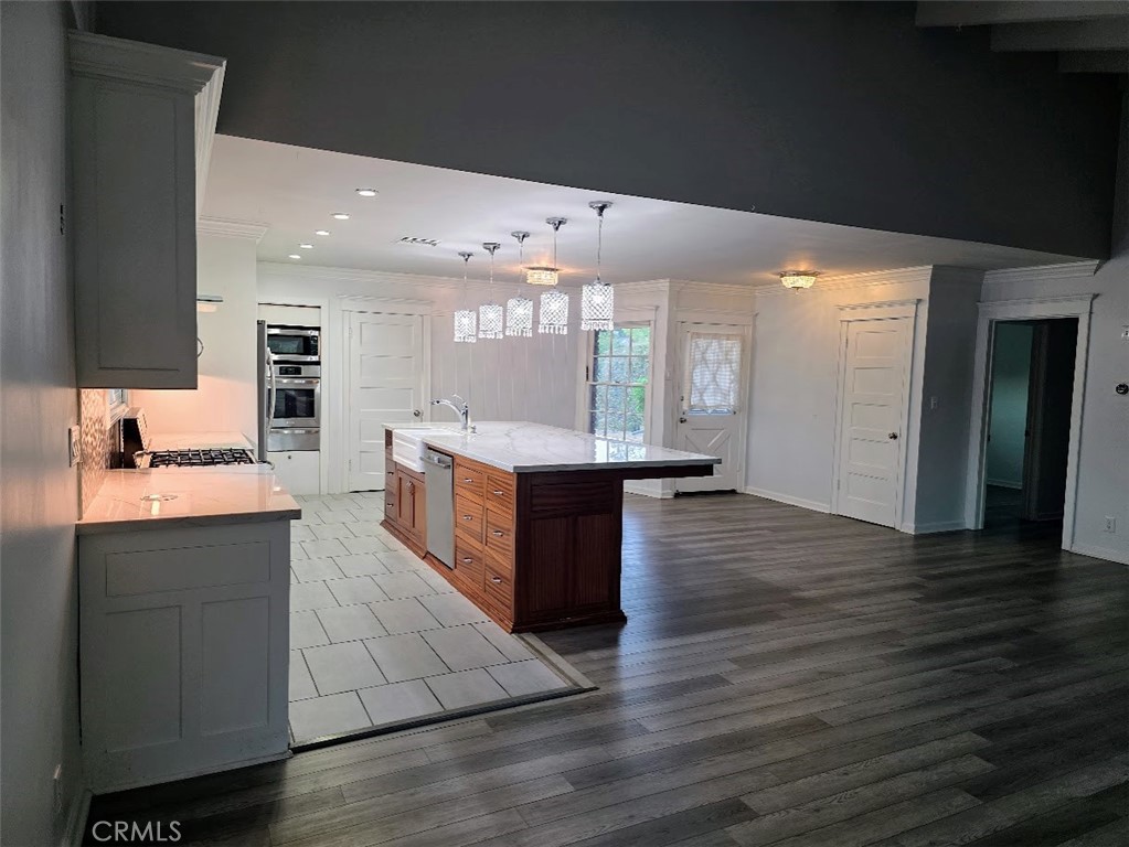 Nestled in a quiet cul-de-sac in a highly desirable Chatsworth neighborhood, this beautifully updated 3-bedroom, 2-bath home sits on an expansive 10,000+ sq ft lot, offering modern comfort and exceptional outdoor living. Inside, enjoy a bright open-concept layout featuring an updated kitchen and bathrooms. The home flows seamlessly to a newer covered patio with ceiling fans and wrap-around stamped concrete, creating a generous space for outdoor entertaining or quiet relaxation. SOLAR PANELS to help with those electric bills. Located near top-rated private and public schools, and just minutes from premier shopping and dining at The Vineyards at Porter Ranch and The Village in Woodland Hills. Surrounded by scenic hiking trails and picturesque mountains, with easy access to the 118 freeway for a smooth commute to Los Angeles or Ventura.