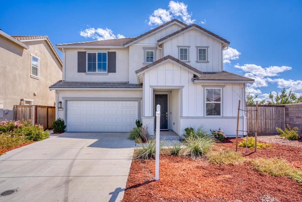 Welcome to your next chapter in this spacious 2022-built home in the thriving city of Lathrop. It feels nearly new and features a bright, open layout. The modern chefs kitchen seamlessly connects to the family room and dining areaperfect for entertaining. The well-designed floor plan offers one bedroom and a full bath on the first floor; upstairs, youll find three additional bedrooms, two baths, and a versatile den ideal for a home office or flex space. The primary suite boasts an extra-large walk-in closet, all enhanced by excellent natural light. Year-round comfort is ensured with central air conditioning and forced-air heating. Highlights include a Tesla charging station in the two-car garage and a professionally landscaped backyard designed for relaxation and entertaining. The premium corner lotwith no neighbor behind or on the right sideprovides exceptional privacy and open scenic views. Conveniently close to Save Mart, Sprouts Farmers Market, and local restaurants, with quick access to I-5, Costco, and Great Wolf Lodge, this home is also located within the Manteca Unified School District, including Lathrop High School. Move-in ready and thoughtfully upgraded, this like-new home combines modern amenities and abundant storageperfect for your next chapter.