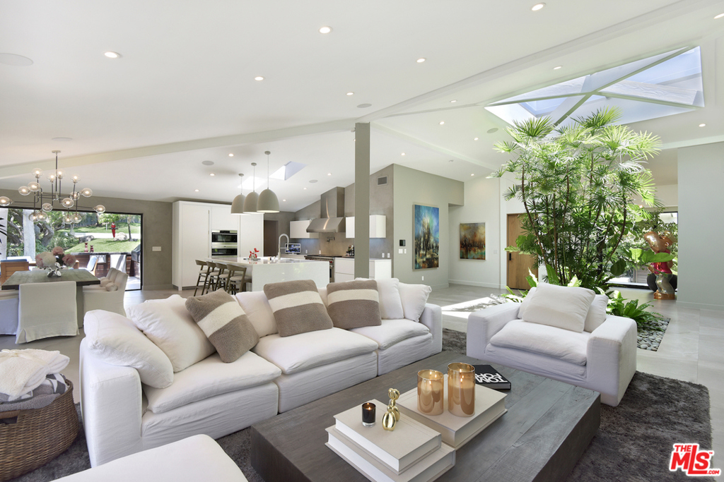 Paradise awaits along the Encinal Bluffs! This rarely offered 3 bedroom Malibu home features an open floor plan bathed in natural light, lush landscaping on .88 acres, a sports court, and highly coveted deeded access to some of the most secluded beaches in all of Malibu. The stunning all glass entry invites you in to view a one-of-a-kind indoor garden featuring tropical plants below a large skylight. The tempting chefs kitchen is outfitted with top-of-the-line appliances and features a center island designed with a hand-selected single piece of marble. Numerous bifold doors are used throughout the home, blurring the lines between indoors and outdoors. The master bedroom features more bifold doors, a large deck with its own hot tub and gym, and has an extravagant master bath with oversized shower and large soaking tub. A bonus room on the second floor has a private deck and picturesque ocean views. A great place for an office or yoga room! Outside, you will discover an expansive lawn, outdoor shower, mature trees along a year-round stream, tropical foliage and palm trees, and a custom designed multi level cascading waterfall. Just off the kitchen there is an outdoor barbecue with custom designed cabinets and a perfect place to enjoy dining outdoors. The home is equipped with a solar system, back up batteries, and electric car charging stations. For security, the private street is gated and the property is also gated. There is room to park 8 or more cars on the large driveway. Also, avail. for lease at $48k per month.