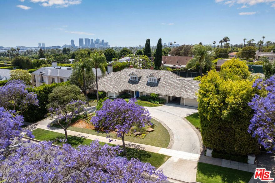 Now available for lease, this beautifully updated 5-bedroom, 5-bathroom traditional estate is located on one of the most prestigious streets in the Beverly Hills Flats. Set on an elevated 21,200+ sq. ft. lot and surrounded by mature jacarandas and lush landscaping, the residence is privately nestled behind a wide circular driveway, offering charm, seclusion, and striking curb appeal. Recently refreshed with new flooring, updated bathrooms, and fresh interior paint, the home features a spacious, light-filled layout with a generous primary suite, guest suite, and multiple formal and informal living areas. Classic architectural elementsincluding dormer windows, stone accents, and a slate roofadd timeless elegance, while the expansive grounds provide exceptional outdoor amenities. A north-south tennis court and sparkling pool are thoughtfully positioned for both privacy and enjoyment, creating the ideal setting for relaxation and entertaining.