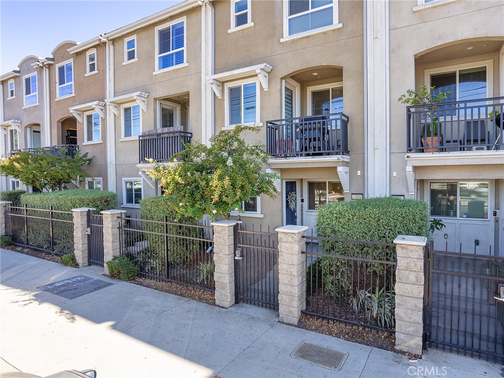 Welcome to this beautifully maintained tri-level single-family home nestled in a desirable gated community. Built just 8 years ago and offering 1,613 square feet of thoughtfully designed living space, this 3-bedroom, 3-bathroom residence blends comfort, style, and efficiency, including fully paid-off solar panels! Step through the gated front porch into a formal entry that sets the tone for the rest of the home. The first level features an attached 2-car garage that opens into a versatile flex room, perfect as a home office, gym, or guest retreat. Upstairs on the second level, you'll find an inviting open-concept layout that seamlessly connects the formal dining room, spacious living area, and a chef-inspired kitchen. The kitchen is a true showstopper, complete with a large center island, sleek white cabinetry, quartz countertops, stainless steel appliances, and recessed lighting. A charming outdoor patio is just off the living space, ideal for morning coffee or evening relaxation. The third level is home to two main bedrooms, each offering walk-in closets and en-suite bathrooms with quartz countertops and walk-in showers. A dream primary suite awaits, and the layout smartly separates the bedrooms with convenient utility and laundry closets. Throughout the home, you'll find wood-toned laminate flooring in the living areas, tile in the bathrooms, and cozy carpet in the bedrooms, stairs, and hallway. Wired for surround sound, this home enhances your lifestyle with an upgraded audio experience throughout. Enjoy year-round comfort with central heating and air, and take full advantage of the gated community's amenities, including a private park, BBQ area, and a playground tucked at the rear of the neighborhood. Don't miss this rare opportunity to own a modern, energy-efficient home with exceptional features and flexible living space!