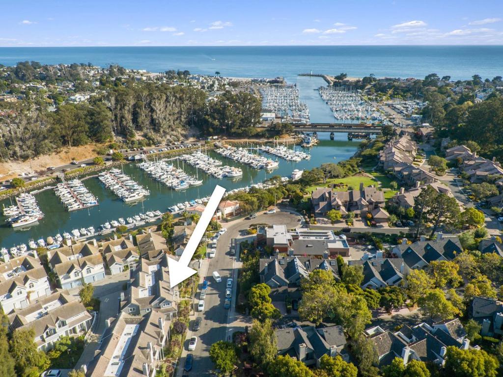 Seas your opportunity to live the best of coastal life by the Santa Cruz Yacht Harbor. This immaculate freshly painted Seabright townhome is just steps from the harbor path and sandy beaches. Enjoy ocean breezes and morning light from multiple decks, including one with a view of the sea. The entry level features a loft-style bedroom suite with full bath and private patio. On the second floor, a spacious primary suite offers a cozy fireplace, private deck, jetted tub, walk-in closet, laundry area, and elevator access. The top floor is built for entertaining with an open-concept living room, formal dining, and large kitchenplus a full bath and additional deck for seamless indoor-outdoor flow. A gated entry, private 2-car garage, and elevator make life easy. Located in the heart of vibrant Seabright, you're a short stroll from the Crows Nest, cafés, parks, and year-round harbor eventsfrom the holiday boat parade to summer fireworks. Relaxation, recreation, and community await.