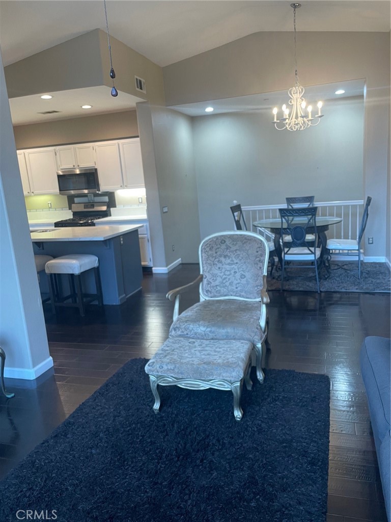 This charming 2-bedroom, 2-bathroom condo offers comfort and convenience with an attached 1-car garage, one extra parking spaces, in-unit laundry, and a modern kitchen featuring a large island, updated countertops, barstool seating, and stainless steel appliances. The open living and dining area includes a cozy fireplace, and a private balcony is perfect for relaxing or entertaining. The primary suite has a walk-in closet, while the second bedroom and bathroom feature stylish finishes. Residents enjoy access to a community pool and spa, and the home is conveniently located near schools, shopping and hospitals.