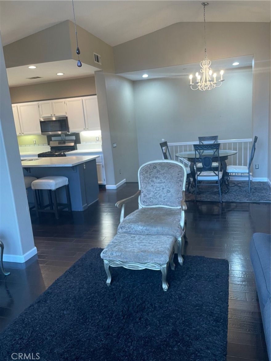 This charming 2-bedroom, 2-bathroom condo offers comfort and convenience with an attached 1-car garage, one extra parking spaces, in-unit laundry, and a modern kitchen featuring a large island, updated countertops, barstool seating, and stainless steel appliances. The open living and dining area includes a cozy fireplace, and a private balcony is perfect for relaxing or entertaining. The primary suite has a walk-in closet, while the second bedroom and bathroom feature stylish finishes. Residents enjoy access to a community pool and spa, and the home is conveniently located near schools, shopping and hospitals.