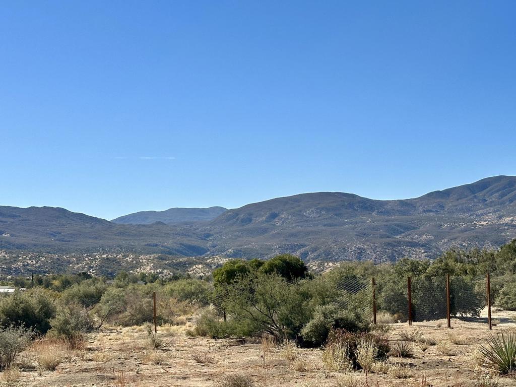 Huge Rare Premium Oversized 1.27 Acre Lot with Well, Water Tanks, Fully fenced and more! Well Tested @ 5.5 GPM and Electrical Breaker box can be used with Generator. Bring your Horses. This property has Amazing Views in all directions and is 100% buildable Land with a fence in the middle to maybe build 2 houses or ADU! Enjoy the Serene Beauty of Pinyon Pines with Hiking Trails and Mountain Views Galore. Only 25 minutes from the Desert and yet about 20 degrees cooler in the Summer.Come see this property today!