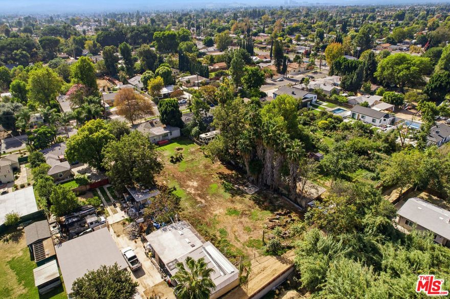 A rare RTI-approved development opportunity in the heart of Reseda, 19211 W Strathern Street offers a fully entitled half-acre lot with plans ready to build a modern multi-residence compound under SB9. Designed by Urbane Design, Inc., the approved plans include Building 1: a remodeled and expanded two-story main home totaling 2,716 square feet with an attached 500-square-foot junior ADU and two-car garage; Building 2: a single-story detached 800-square-foot ADU with its own two-car garage; and Building 3: a newly constructed SB9 two-story residence totaling 2,466 square feet with an attached 1,000-square-foot ADU and two-car garage. Together, the project encompasses approximately 8,299 square feet of all-electric living. Each residence is designed with modern efficiency and architectural harmony, featuring NFPA 13D/13R sprinkler systems and full compliance with Los Angeles's all-electric ordinance. Zoned RA-1 and eligible for AB 2097 parking exemption within half a mile of a major transit stop, this property offers exceptional flexibility for investors, builders, or end users envisioning a private estate or income-producing multi-unit community. With permits ready to issue and no entitlement delays, this is a rare opportunity to break ground immediately and bring a sophisticated, design-forward project to life on one of Reseda's largest RTI-approved lots. Approved RTI plans available for review upon request.