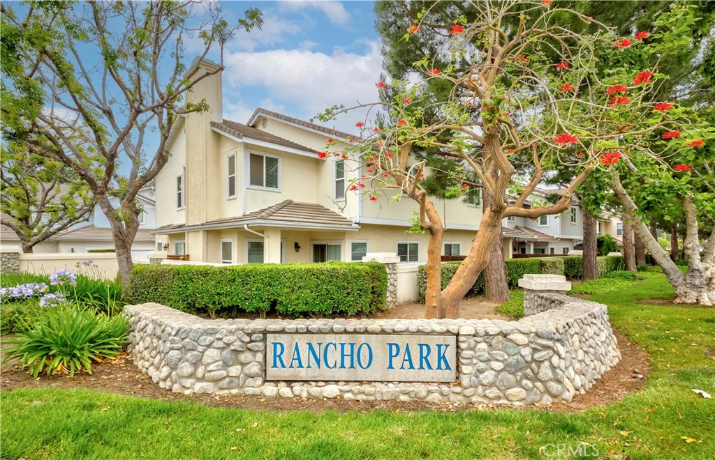 VA & FHA eligible — Property is an attached SFR, not a condominium! *THE BEST VALUE IN TOWN* Located in the desirable gated Rancho Park Ventures community. Prime lot with privacy. This well-kept single-family attached home offers 4 bedrooms and 3 bathrooms, including a downstairs bedroom with a full bath—ideal for guests or extended family. The open layout features a bright living room with high ceiling, fireplace, adjoining dining area, and an updated kitchen with ample cabinets, pantry, and counter space, plus a breakfast nook. Upstairs, the spacious primary suite offers room for a king-size bed and a sitting area. The primary bathroom includes dual sinks, a vanity, and a large walk-in closet. Two additional upstairs bedrooms share a full hallway bath. A large laundry room with sink and built-in storage is conveniently located on the main floor. Upgrades include recessed lighting, newer wood-look flooring, and neutral interior paint. The private backyard with a covered California room is ideal for outdoor use. Attached side-by-side 2-car garage with direct access. Community amenities include a gated pool, spa, and clubhouse with low HOA dues.