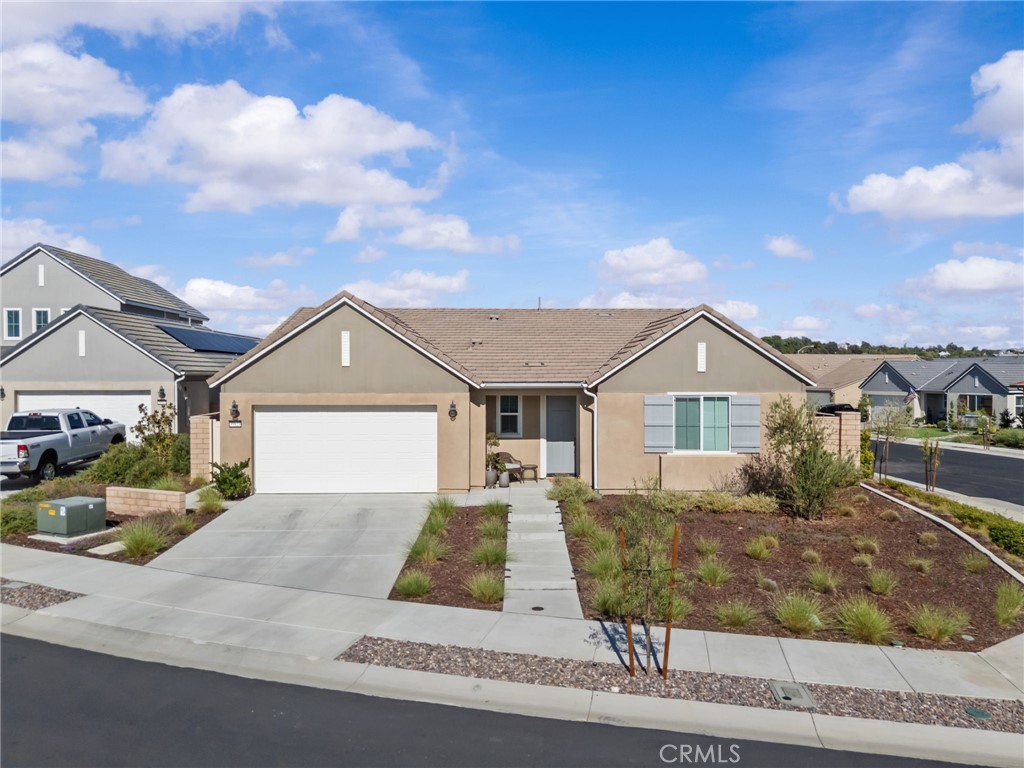 GATED 55+ COMMUNITY | ESPLANADE AT SOMMERS BEND | CUL-DE-SAC | CORNER LOT | PAID-OFF SOLAR | TANKLESS WATER HEATER | LARGE LOW-MAINTENANCE BACKYARD | SINGLE STORY | You have Arrived! This beautiful home features 3 bedrooms and 2.5 bathrooms with a thoughtfully designed open-concept floor plan. As you enter through the front door, you’re immediately greeted by a spacious family room that flows seamlessly into the dining area and kitchen.
The kitchen is a chef’s delight with a large center island and a walk-in pantry, offering both style and functionality.
The primary suite is privately situated down the hall, featuring a generously sized walk-in closet and a spa-like bathroom with an oversized walk-in shower. Two additional bedrooms and a full bath provide comfortable space for guests or a home office.
Step outside to your backyard retreat, complete with an extensive aluminum patio cover, a cozy outdoor gas fireplace, and low-maintenance landscaping with turf and concrete walkways, ideal for relaxing and entertaining year-round.
Living in Esplanade means access to exclusive resort-style amenities, including a clubhouse, pool, fitness center, and more. All this, just minutes from Temecula Wine Country, shopping, and dining.
This home perfectly blends comfort, convenience, and community. Don’t miss the opportunity to make it yours!