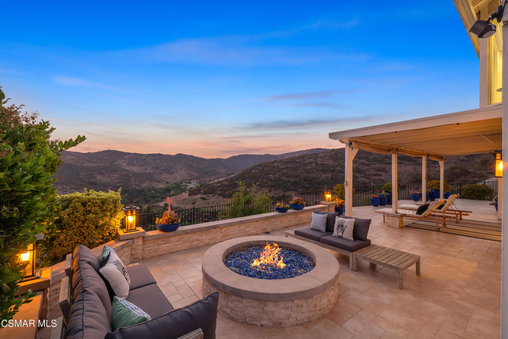 Top-of-the-Mountain Privacy Sweeping Bird's-Eye Views Fully Remodeled Luxury. Perched on a premium view lot in the prestigious Ridgeview Estates of Westlake Village, this exquisitely reimagined residence offers rare elevated privacy, stunning panoramic views, and over $250,000 in recent upgrades. Fully transformed inside and out, the home features a brand-new HVAC system with in-attic furnace, exterior Bosch condenser, zoned climate control, all-new ductwork with added vents, and enhanced attic insulation from a full clean-out. A new tankless water heater provides on-demand efficiency, while a Halo 5 whole-house water filtration system ensures the highest water quality. The chef's kitchen is a showpiece with white shaker cabinetry, quartz countertops, soft-close drawers, a glass tile backsplash, professional-grade Viking range, and built-in Thermador refrigerator. Bathrooms have been fully remodeled, including a custom primary bath with an oversized shower featuring half-inch piping and three shower heads, a soaking tub framed by floor-to-ceiling picture windows, dual vanities, heated towel racks, and Toto bidet toilets in all three bathrooms. Additional upgrades include a downstairs fireplace overhaul, new wrought iron front and garage doors, custom wood staircase with wrought iron railings, added garage storage racks, and a custom walk-in primary closet with built-ins. The open floor plan boasts vaulted ceilings, a formal dining room, and a warm family room with a stacked-stone fireplace. A downstairs bedroom and full bath offer ideal flexibility for guests, a home office, or multi-generational living. Upstairs, the primary suite is a true retreat with vaulted ceilings, a bay window, fireplace, and elegant custom moldings. Step outside to enjoy an expansive covered patio with a built-in fire pit, perfect for taking in the incredible views and starlit skies. Ideally located just minutes from award-winning Conejo Valley schools, upscale shopping, dining, scenic hiking and biking trails, and the lake, this home perfectly blends luxury, comfort, and the best of Westlake Village living.