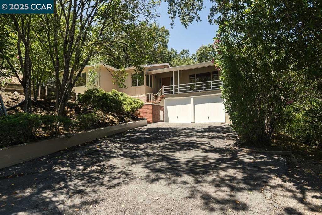 Welcome to Lafayette! Splendid contemporary with view balcony just minutes to downtown, shopping, BART and freeways. Fresh carpet and paint, rich wood and laminate flooring, fabulous beamed ceilings, lovely fire place, serene setting with trademark floor-to-ceiling windows, gorgeously remodeled guest bath, eat-in kitchen, outstanding patio, sweeping lawn, superb yard spaces with room for possible executive suite, 2-car garage with separate room/shop/wine cellar storage space, fantastic off-street parking. Enjoy the best of California living in addition to top-ranked Lafayette schools.