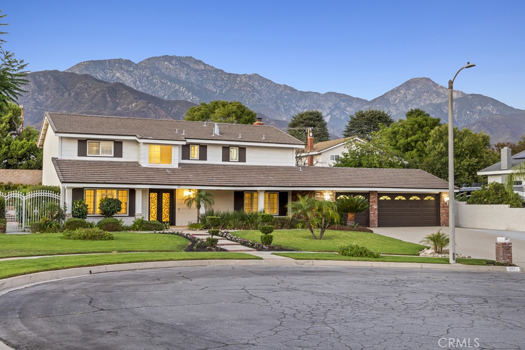 Welcome to this stunning two-story home offering 2,523 square feet of living space on an expansive 16,640 sq. ft. lot. Perfectly situated on a peaceful cul-de-sac, this residence combines modern updates with timeless charm, all while showcasing breathtaking mountain views. The beautifully landscaped grounds feature a large in-ground heated pool and spa, ideal for relaxing or entertaining. The spacious backyard is enhanced with newer concrete, providing the perfect setting for gatherings, plus ample RV parking for added convenience. A finished 3-car garage with epoxy flooring offers both function and style. Inside, the remodeled kitchen shines with quartz countertops, soft-close white cabinetry, and a bright, airy atmosphere that flows into the casual breakfast nook. The home offers both a formal living room and dining room, each generously sized for entertaining. The family room with a cozy fireplace provides the perfect place to unwind. All bedrooms are upstairs, offering privacy and comfort, and each is spacious with plenty of natural light. The primary suite is a true retreat, featuring a spacious, updated bathroom with double sinks, a large step-in shower, and an overhead shower faucet for a spa-like experience. Additional highlights include the updated staircase with newer railing, stylish shutters throughout, and a 3-year-old water heater. This home is the perfect blend of comfort, style, and function—inside and out.