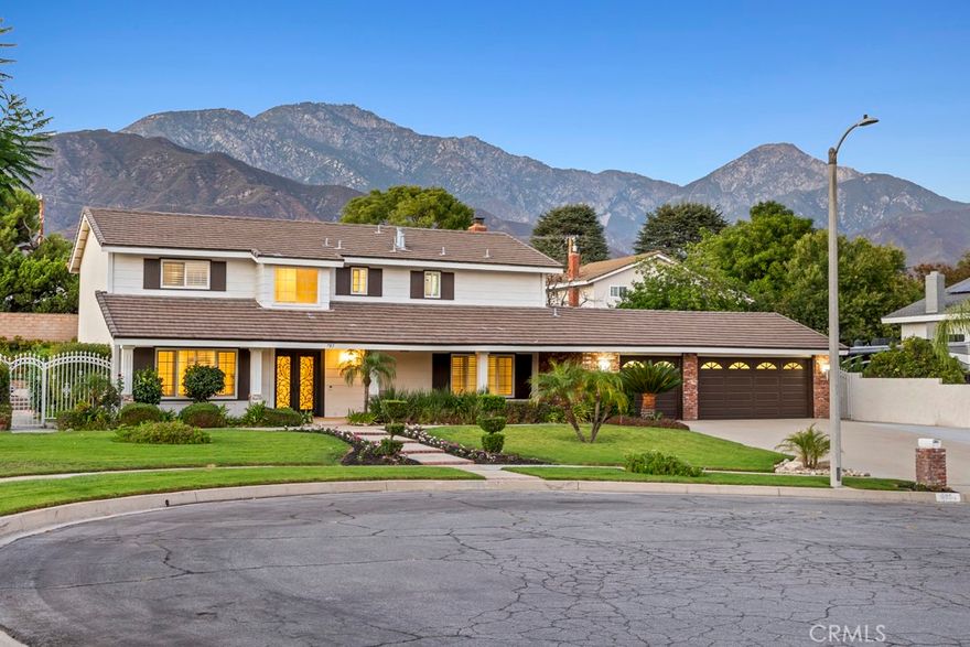 Welcome to this stunning two-story home offering 2,523 square feet of living space on an expansive 16,640 sq. ft. lot. Perfectly situated on a peaceful cul-de-sac, this residence combines modern updates with timeless charm, all while showcasing breathtaking mountain views. The beautifully landscaped grounds feature a large in-ground heated pool and spa, ideal for relaxing or entertaining. The spacious backyard is enhanced with newer concrete, providing the perfect setting for gatherings, plus ample RV parking for added convenience. A finished 3-car garage with epoxy flooring offers both function and style. Inside, the remodeled kitchen shines with quartz countertops, soft-close white cabinetry, and a bright, airy atmosphere that flows into the casual breakfast nook. The home offers both a formal living room and dining room, each generously sized for entertaining. The family room with a cozy fireplace provides the perfect place to unwind. All bedrooms are upstairs, offering privacy and comfort, and each is spacious with plenty of natural light. The primary suite is a true retreat, featuring a spacious, updated bathroom with double sinks, a large step-in shower, and an overhead shower faucet for a spa-like experience. Additional highlights include the updated staircase with newer railing, stylish shutters throughout, and a 3-year-old water heater. This home is the perfect blend of comfort, style, and function—inside and out.