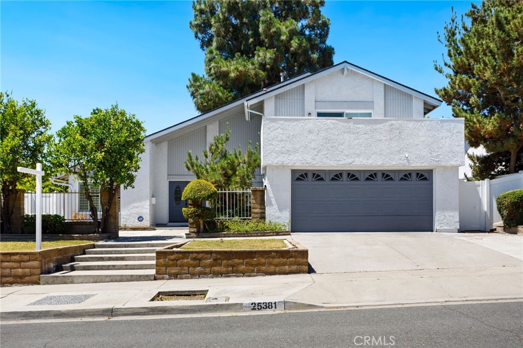 Discover a rare blend of sophistication and comfort in this beautifully reimagined estate nestled in one of Laguna Hills’ most sought-after neighborhoods. Set on a meticulously landscaped 7,100 sq ft lot, this 4-bedroom, 3-bath home spans over 2,200 sq ft of thoughtfully curated living space—where classic craftsmanship meets modern elegance. Originally built in the 1970s and now fully transformed, the residence boasts an open-concept design filled with natural light, high-end finishes, and an effortless indoor-outdoor flow. A downstairs bedroom and full bathroom offer ideal flexibility for multigenerational living, a home office, or hosting guests with ease. The main living areas are flooded with sunlight through expansive dual-pane windows and sliding doors, while recessed LED lighting sets the perfect mood throughout. The gourmet kitchen is a showstopper—featuring sleek grey stone countertops, white shaker cabinetry, and top-tier stainless steel appliances—designed to inspire both everyday meals and entertaining alike. Upstairs, the spacious primary suite offers a peaceful retreat with a private balcony, perfect for savoring your morning coffee or unwinding at sunset. The spa-like ensuite bathroom features dual vanities, a walk-in glass shower, and custom finishes that elevate the everyday. Beyond the stunning interiors, this home delivers a lifestyle of true convenience and prestige. Located near top-rated schools, luxury shopping, fine dining, equestrian centers, and scenic trails, you'll enjoy easy access to John Wayne Airport, major freeways (I-5 and I-405), and the world-renowned beaches of Laguna. From its elevated design to its prime location, this is more than just a home—it’s an invitation to experience the best of Southern California living.