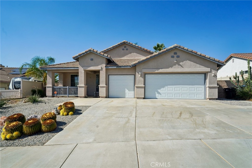 Welcome to 27670 Hub Circle in the beautiful city of Menifee. This single-story home offers four bedrooms, two bathrooms, and a spacious three-car garage with RV parking potential. The front yard showcases drought-tolerant landscaping, while inside you’ll find luxury vinyl plank flooring throughout. As you step through the front door, the formal living room sets the tone before flowing into the open-concept great room, combining the kitchen, dining area, and family room. The kitchen features a large island with bar seating, oak cabinetry with subway tile backsplash, and dark stainless steel appliances, all overlooking the family room complete with a cozy fireplace. The generous primary suite includes a private slider to the backyard, a double vanity, separate tub and shower, and a walk-in closet. Three additional bedrooms are located on the opposite side of the home, along with an updated guest bathroom featuring a newly tiled shower. The AC unit has replaced last year with a dual fan unit with a ultra violet air purifier giving you hospital grade clean air. The backyard offers plenty of space for entertaining or relaxing, with mature palm trees, storage sheds, and a grass area. With low taxes, NO HOA, and NO solar, this home is the perfect blend of comfort and convenience.