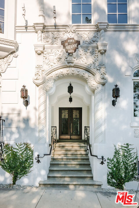 After nearly a century standing proudly in the heart of West Hollywood, the breathtaking El Mirador Apartments reopens its doors. Reborn, refined, and ready to welcome a new generation of residents. Following more than a decade of meticulous and sensitive restoration, this architectural jewel is a prime example of Churrigueresque Spanish Colonial Revival design and has been returned to its original splendor. Built in 1929 by renowned theater architect S. Charles Lee, it stands as a remarkable tribute to its era. Original floorboards were carefully lifted, revarnished, and placed back with reverence. Decades of paint and primer were patiently removed from hand-carved archways to reveal the craftsmanship beneath. Custom-imported rugs now line the grand corridors. Every salvageable element of the building's storied past has been preserved, fought for in some cases, with an unrelenting commitment to authenticity. In El Mirador, the devil is not just in the details. It is in the devotion. Inside each residence, modern comforts blend seamlessly with historic charm. Kitchens feature state-of-the-art appliances set in sleek marble surrounds. Discreet cabinetry conceals in-unit washers and dryers, while retractable screens disappear into window casings to preserve uninterrupted views. Modern comforts seamlessly blend with historic charm.