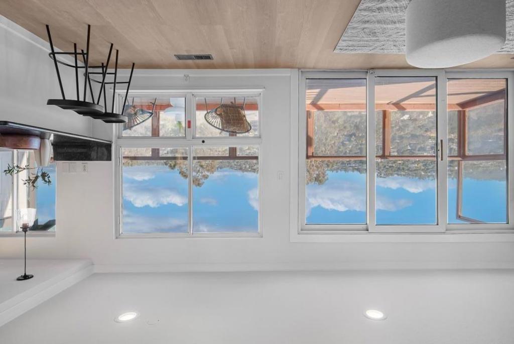Tucked away in the serene hills of Belmont, this beautifully updated home spans two levels and showcases sweeping views of the San Francisco Bay and surrounding canyons. A gated entry leads you along a private path into a charming courtyard. Double doors open to the main level, where a warm and inviting living room connects to the formal dining area. The space flows seamlessly into an updated kitchen and a spacious family room - where breathtaking panoramic views of the Bay and canyon unfold before you. Step out onto the rear patio to fully take in the scenery. Upstairs, the expansive primary suite features a private balcony with unobstructed views, a walk-in closet, and an elegant en-suite bath. Two additional generously sized bedrooms share a naturally bright hall bathroom. Nestled in a sought-after Peninsula neighborhood, this home is centrally located near top-rated Belmont schools, Carlmont Village Shopping Center, the public library, and major highways. This is a rare opportunity to enjoy modern comfort, spectacular views, and a prime Peninsula location all in one exceptional home. Don't miss your chance to make it yours!