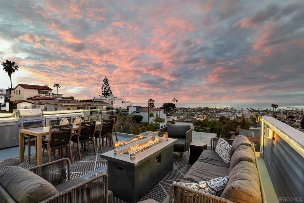 Sellers will consider offers from $2,995,000 - $3,225,000. Welcome to your dream retreat, w/ stunning Pacific Ocean views. Custom-built in 2023 with a fresh, modern design, this one-of-a-kind home captures panoramic ocean, bay, and mountain views from nearly every room. Inside, soaring ceilings, walls of glass, and disappearing sliders flood the living spaces w/natural light, blending indoors and out. The gourmet kitchen with quartz countertops, custom cabinetry, and a striking ocean-blue ZLINE six-burner range, a stylish nod to the nearby waves. Thoughtfully designed for indoor-outdoor living, this home offers three expansive outdoor spaces, including a spectacular rooftop deck. Warm and inviting, the fire pit adds to the ambience, perfect to relaxing or entertaining under the San Diego sky. The flexible layout includes a first-floor private suite with its own entrance, spa-inspired bathroom, and oversized patio, ideal for guests or as a potential Airbnb rental. Exquisite fixtures and refined finishes including hardwood and hand poured epoxy floors are found throughout this stunning home. Located in one of Ocean Beach’s most desirable pockets, just moments from Sunset Cliffs, the OB Pier, beaches, vibrant Newport Avenue, and downtown attractions like Little Italy, the Shell, Petco Park, and the San Diego Zoo.