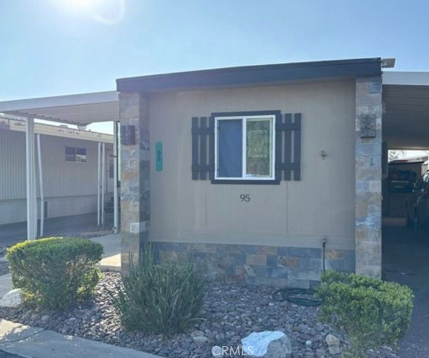 Spacious 2 brm/ 1 bath mobile in a Senior community. This home has a large living room, dining room, kitchen with moveable island, washer/dryer hookup, double pane windows, outside sitting area and small side yard. Centrally located, close to shopping, dining and mall.