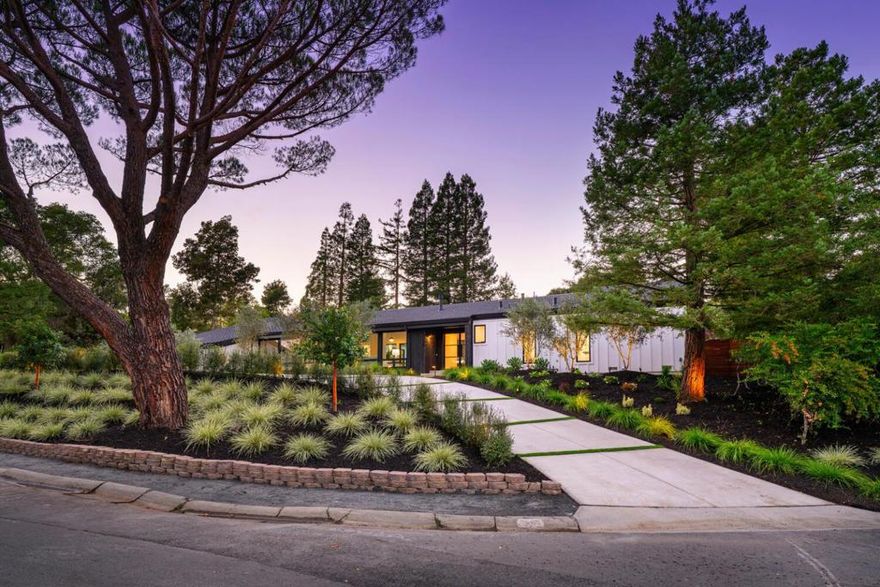 Situated on a serene cul-de-sac, this stunning, fully renovated modern farmhouse offers resort-style living on a mostly level +/-0.52-acre lot. With +/-4,200 s.f. of bright open space, the 5BR/4.5BA Napa Valley-style home features soaring ceilings, wide-plank hardwood floors, and walls of windows that flood the interior with light. A striking glass front door opens to the living room with dramatic fireplace and verdant views. The elegant dining room includes a sleek, temperature-controlled wine display, while the chef's kitchen with top-tier appliances, large island, and breakfast nook flows into the expansive great room with access to the backyard. The private bedroom wing offers 4 sizeable bedrooms, one with an ensuite bath, a separate hall bath, powder room, laundry, and the lavish primary suite with custom walk-in closet and spa-inspired bath with soaking tub & oversized shower. Additional spaces include an attached ADU with kitchenette, full bath which opens to the pool patio, and loft, plus a versatile lower-level bonus room ideal as an office or gym, and 3-car garage. Resort-like grounds boast mature olive trees, stunning landscaping, sprawling patio, level lawn, outdoor kitchen, and new pool with spa. A rare opportunity to own a virtually new home in a remarkable setting.