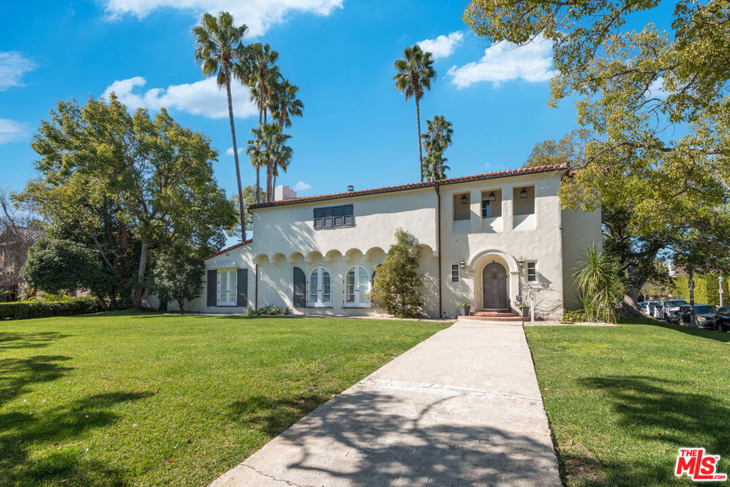 Grand Hancock Park Estate on Coveted Tree-Lined Street Half-Acre Lot Located on one of Hancock Park's most picturesque and sought-after streets, this stately residence is set on an expansive half-acre lot, offering the rare combination of timeless elegance and resort-style amenities in the heart of the city. Originally constructed with classic architectural integrity, the home underwent a complete rebuild down to the studs in 2010, resulting in a masterfully reimagined estate where sophisticated design meets modern function. Every room is thoughtfully oriented to capture panoramic views of the lush, park-like grounds, creating a seamless connection between indoor and outdoor living. The centerpiece of the outdoor space is an Olympic-sized swimmer's pool with an automatic cover, set against the backdrop of a striking resort-style cabana, oversized outdoor fireplace, and a fully equipped BBQ kitchen perfect for grand-scale entertaining or intimate family gatherings. Inside, the home features a spacious gourmet eat-in kitchen that opens to both the family room and backyard, ideal for modern living. The formal living room boasts soaring beamed ceilings and a fireplace, while a richly appointed wood-paneled library offers a cozy retreat. A guest suite with separate entrance and a private office complete the main level. Upstairs, the dramatic vaulted staircase leads to five generously sized bedrooms, including a luxurious primary suite with spa-inspired bath, dual walk-in closets, a secluded patio & sitting area with fireplace overlooking the grounds. This extraordinary property is a showcase for the best of Southern California indoor/outdoor living, offering unparalleled space, comfort, and style in one of Los Angeles' most prestigious neighborhoods. Tennant occupied until March 2026. Please do not disturb the tenants.