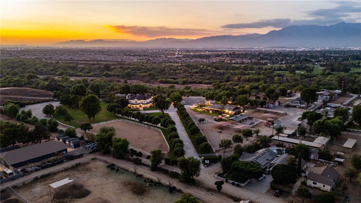 Welcome to The Farm in Norco, a nearly 25 acre equestrian estate and CUP entitled wedding venue with Santa Ana River frontage in HorseTown USA. This rare offering blends luxury living, proven income, and equestrian amenities.
Operating under a Conditional Use Permit for weddings and special events, the venue is fully legal and thriving, with 15 weddings booked for 2025 and another 15 secured for 2026, representing more than $530,000 in confirmed event revenue and growing. Two additional homes on the property can generate approximately $66,000 annually if leased, bringing combined income potential to nearly $600,000 per year.
The 5,500 square foot main residence offers five bedrooms, six baths, dual staircases, a chef’s kitchen, game room, and library. Outdoor living includes a resort style pool with waterfall and spa, outdoor kitchen, koi pond, and expansive patio.
Event facilities feature a 3,000 square foot ADA compliant barn with seating for 200, fire sprinklers, chandeliers, catering kitchen, restrooms, décor storage, and a charming bride’s cottage. Manicured lawns, arches, string lighting, and a horse drawn carriage complete the wedding setting.
Equestrian amenities include a four stall barn with tack and feed rooms, sheltered turnouts, and a riding arena. Ingalls Park is less than two miles and ride direct to Norco's trails from the property, including those along the Santa Ana River.