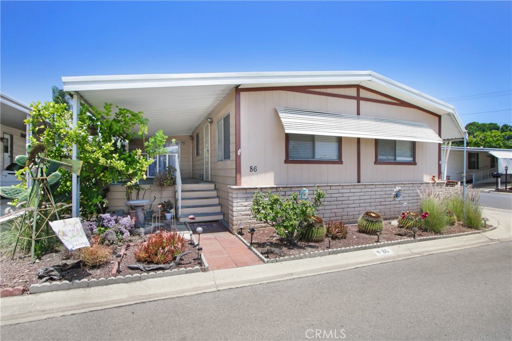 RARE CORNER LOT in Desirable Twin Oaks 55+ Community!
Welcome to this spacious 2-bedroom, 2-bathroom home in the highly sought-after Twin Oaks Mobile Home Park, a 5-star senior community. This well-maintained home offers approximately 1,726 sq. ft. of comfortable living space and is ideally located on a rare corner lot that brings in abundant natural light.
Step into the large front living room, featuring expansive picture windows and a ceiling fan for a bright and inviting atmosphere. The dining area includes a charming built-in china cabinet, perfect for displaying your treasures.
The kitchen features laminate flooring, a gas range, dishwasher, pantry, and a breakfast bar with a window overlooking the front porch. It opens to a spacious family room (approx. 130 sq. ft., included in total), great for relaxing or entertaining. A sliding glass door leads to the covered front porch—ideal for morning coffee or evening sunsets.
The primary suite offers mirrored closet doors and a generously sized en-suite bath with a walk-in shower, built-in vanity, and ample cabinet space. A bonus room off the primary bedroom (approx. 156 sq. ft., included in total square footage) with its own closet makes a perfect home office, craft room, or quiet retreat.
Additional features include a separate laundry room with direct access to the extended carport—fits up to 3 cars—and includes a ramp and stairs for easy entry, plus a convenient storage shed.
Bring your personal touch and make this lovely home your own in one of the area’s most desirable senior communities!
Twin Oaks Community Amenities:
Clubhouse
Pool & Spa
Fitness Center & Sauna
Billiards & Card Room
Multi-Purpose Event Room
Located near shopping, dining, hospitals, public transportation, major travel routes, and airports—Twin Oaks offers the best in 55+ living.
(Home is on REGISTRATION. New Space Rent: $800.08 )
