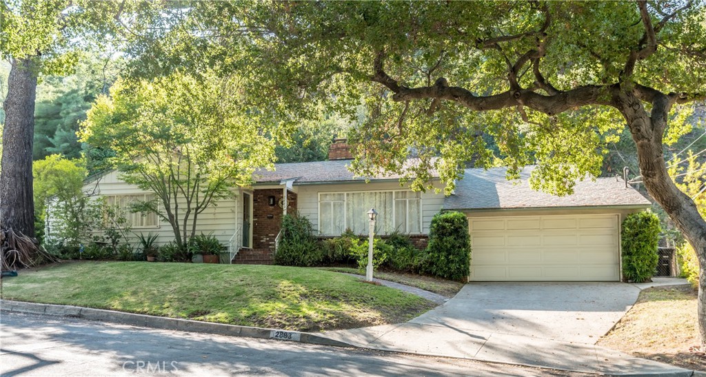 Built in 1954 is a charming 2 bedroom, 1.5 bath, 1629 square foot home, located on a picturesque tree-lined street in desirable Verdugo Woodlands. Freshly painted interior, newly installed carpet in the spacious living room with fireplace, dining area and front bedroom. Floor-to ceiling brick fireplace with raised hearth and French doors in the family room. Light and bright kitchen with granite counters, glass front cabinetry, pantry space, gas cooktop, wine rack and garden window. Convenient laundry area and half bath. A breakfast nook with French doors opens to the patio. The rear yard backs to a hillside. Original hardwood floors in entry, family room, hallway and secondary bedroom. Full bath with separate shower and tub is ready for your remodeling design. Both bedrooms have cedar lined closets. Front entry closet, hall closet and drawers and large closet in family room provide ample storage space. Attached two-car garage with deep driveway. This sought-after neighborhood is near Verdugo Park, historic Catalina Verdugo Adobe and close to schools, Glendale Civic Auditorium, Glendale Community College. Easy access to the 2 and 134 freeways and points of destination in LA and surrounding cities. HERMOSITA means BEAUTIFUL! Live the life you have imagined, live the life you deserve! Come home to 2883 Hermosita Drive, Glendale.