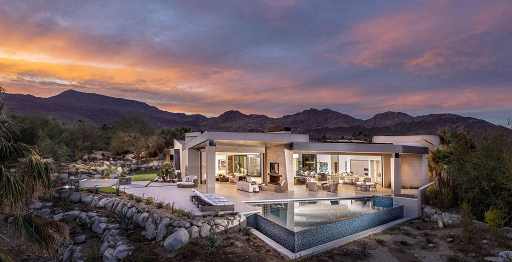 New Construction. Stunning architecture with views in every direction. This south facing location and the seamless transition from indoors to outdoors is the the essence of desert living. Gated entry courtyard opens to an expansive water feature with floating fire pits. Open spaces and floor to ceiling glass compliment the contemporary finishes and furnishings throughout. The master wing is privately tucked to one side with an office overlooking a water feature. wo completely separate guest accommodations and both offer a guest living room and 2 bedrooms/2bathrom. An incredible estate within an amazing Club.