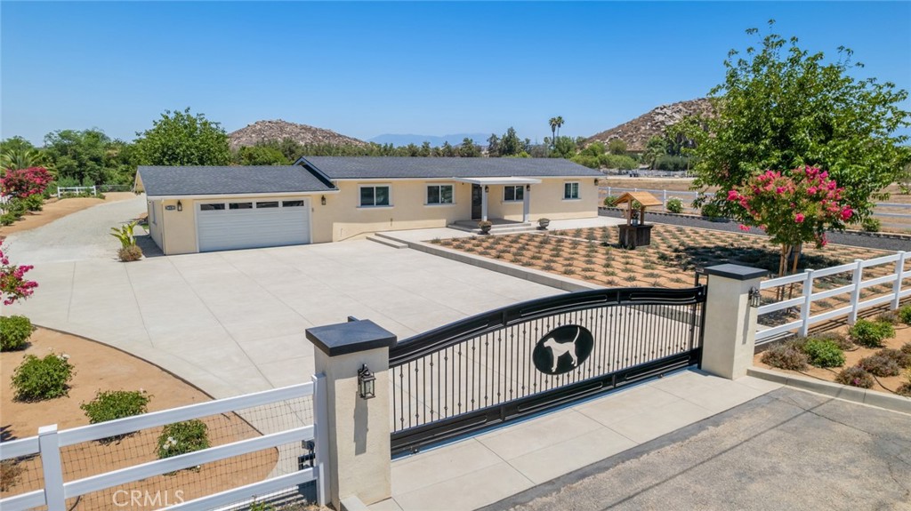 Honey Stop The Car!!! This absolutely gorgeous 1 story home is move in ready and sits on over 3/4 acres all flat & useable land. This home shows pride of ownership both inside & outside. From the moment you drive up to the double face custom wrought iron gate you are enthralled with the attention to detail given on the beautiful landscape & hardscape surrounding the property. You have not 1, but 2 entrances at the front of the property. The entrance to the right is a double swing door that allows for plenty of room for a RV. The main gate has remote access & smart accessibility when connected to wifi. The fencing surrounding the front & sides of the home is PVC with non-climb horse wire. Hardscape & landscaping is a variety of concrete, black lava rock, artificial turf, lavender trailing ice plant, gravel and pebble. All concrete is rated for heavy vehicles, 5 inches thick with rebar (top cast finish). The home is also surrounded by Crape Myrtle Trees & Iceberg Roses. There are also draught tolerant plants, Sycamore Tree, many fruit trees that include Orange, Lemon, Fig, Peaches, Nectarines, Avocado, Pink Guava, Pomegranate, Grapes, Blackberries, Raspberries & a fenced in Vegetable Garden. Backyard is perfect for entertaining! Some of the highlights are:large concrete patio with 55x18ft insulated alumawood lighted cover, above ground 35x15ft pool with trex decking & LED lighting which was installed less than 1 year ago, beautiful outdoor restroom & a Container for Storage (electricity connected). This home also boasts an oversized garage with smart garage door system. Some of the upgrades & updates include: Roof, A/C System, Double Pane Windows, Custom Cabinets throughout, Engineered waterproof laminate flooring, Walk-In Showers w/Rain Shower Heads, Quartz Countertops, Paint, Lighting, Stainless Steel Appliances, Upgraded Sink & Fixtures, LED Mirrors in Bathrooms, Doors, Tankless Water Heater, Stucco, Rain Gutters, Smart Thermostat, Gazebo Pad w/footings, RV connections. Not to mention that this home is located off of a paved street minutes from schools, shopping and freeway with plenty of room to add on.