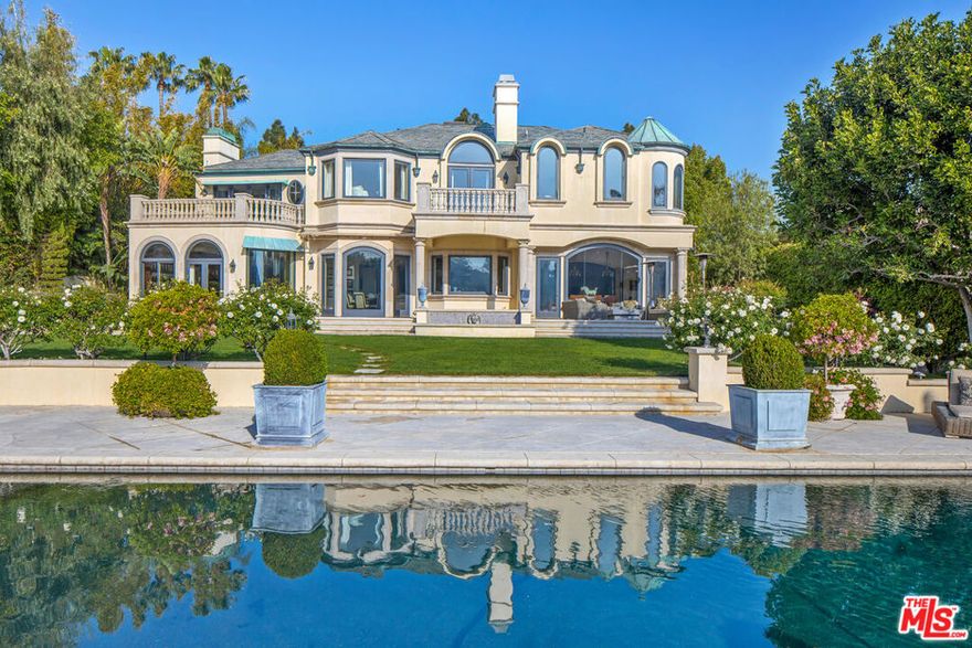 Fully Furnished French Chateau Estate. A spectacular residence set on over a half-acre, boasting the most coveted views in Mulholland Estates, a prestigious 24-hour guard-gated community. Behind grand iron gates, step into refined luxury with a dramatic two-story foyer and sweeping spiral staircase. The home showcases a formal living room with herringbone wood floors, a wood-paneled library, family/media room, formal dining room, and a gourmet kitchen with marble backsplash, Viking appliances, and water filtration system all overlooking manicured grounds, a tranquil fountain, and breathtaking views. The grand primary suite features a step-down sitting area with a double-sided fireplace, a custom marble bath with deep soaking tub, and a spa-like sauna. The private backyard is an entertainer's paradise with a sparkling pool, spa, multiple lounge areas, and a built-in BBQ. Available for lease fully furnished, offering a turnkey lifestyle in one of the most exclusive communities in Los Angeles.