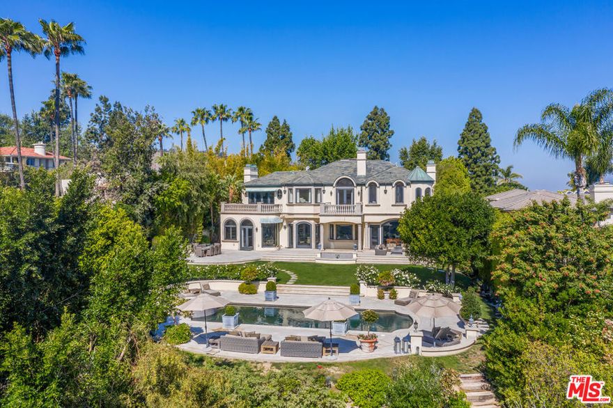 Fully Furnished French Chateau Estate. A spectacular residence set on over a half-acre, boasting the most coveted views in Mulholland Estates, a prestigious 24-hour guard-gated community. Behind grand iron gates, step into refined luxury with a dramatic two-story foyer and sweeping spiral staircase. The home showcases a formal living room with herringbone wood floors, a wood-paneled library, family/media room, formal dining room, and a gourmet kitchen with marble backsplash, Viking appliances, and water filtration system all overlooking manicured grounds, a tranquil fountain, and breathtaking views. The grand primary suite features a step-down sitting area with a double-sided fireplace, a custom marble bath with deep soaking tub, and a spa-like sauna. The private backyard is an entertainer's paradise with a sparkling pool, spa, multiple lounge areas, and a built-in BBQ. Available for lease fully furnished, offering a turnkey lifestyle in one of the most exclusive communities in Los Angeles.