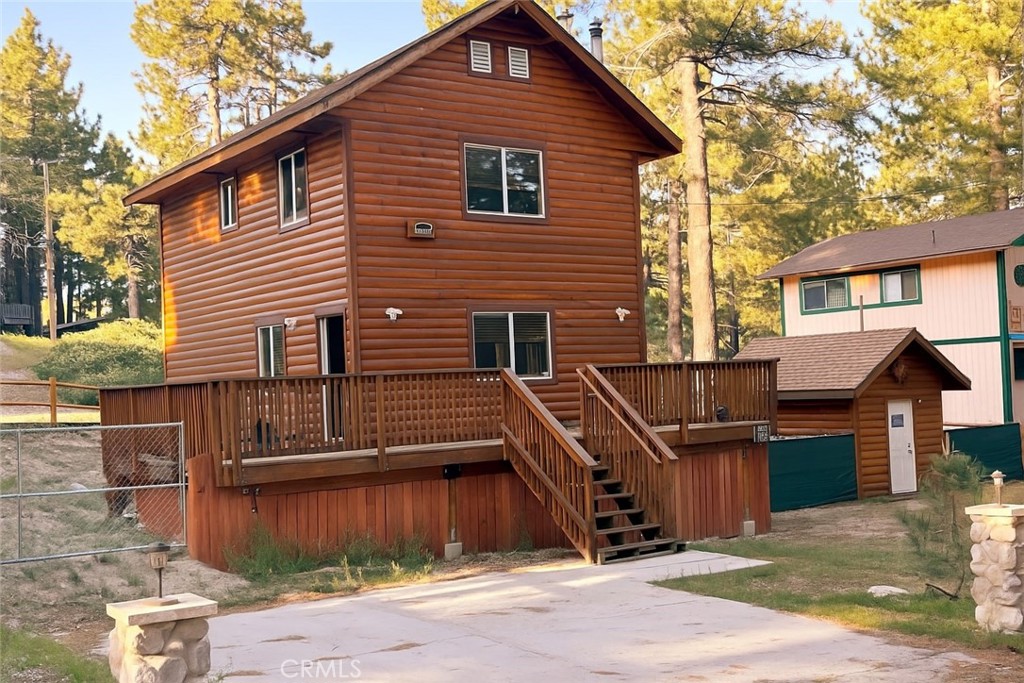 Built in 2008 and lightly used as a second home, this beautifully maintained log-style retreat offers the perfect blend of rustic charm and modern convenience. Set on three lots—one with additional utilities—this home features two spacious bedrooms, 1.5 baths, and three inviting decks to enjoy the mountain air. Inside, you’ll find wood finishes throughout, a cozy wood-burning stove, and a gas fireplace in the primary bedroom. The kitchen includes butcher block countertops, stainless steel appliances, and convenient access to the backyard. A stackable washer/dryer and basement access through the interior add functionality. With room to park your RV or boat, plus three shares in the local water company, you’ll enjoy the ability to purchase annual passes for fishing, boating, and swimming. The forest is just a short stroll away, making this the ideal mountain escape. Estimated rental income is: $31,600. 3rd party proforma data available by request.